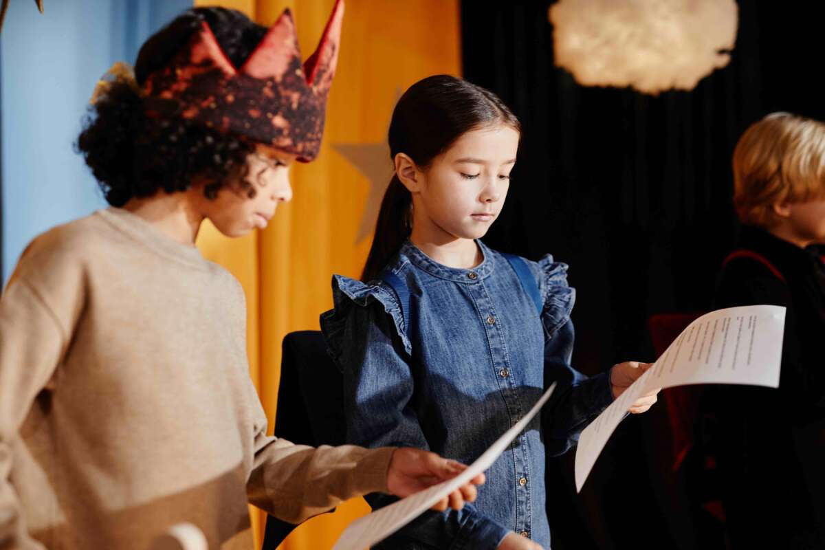 Young students preparing for a play