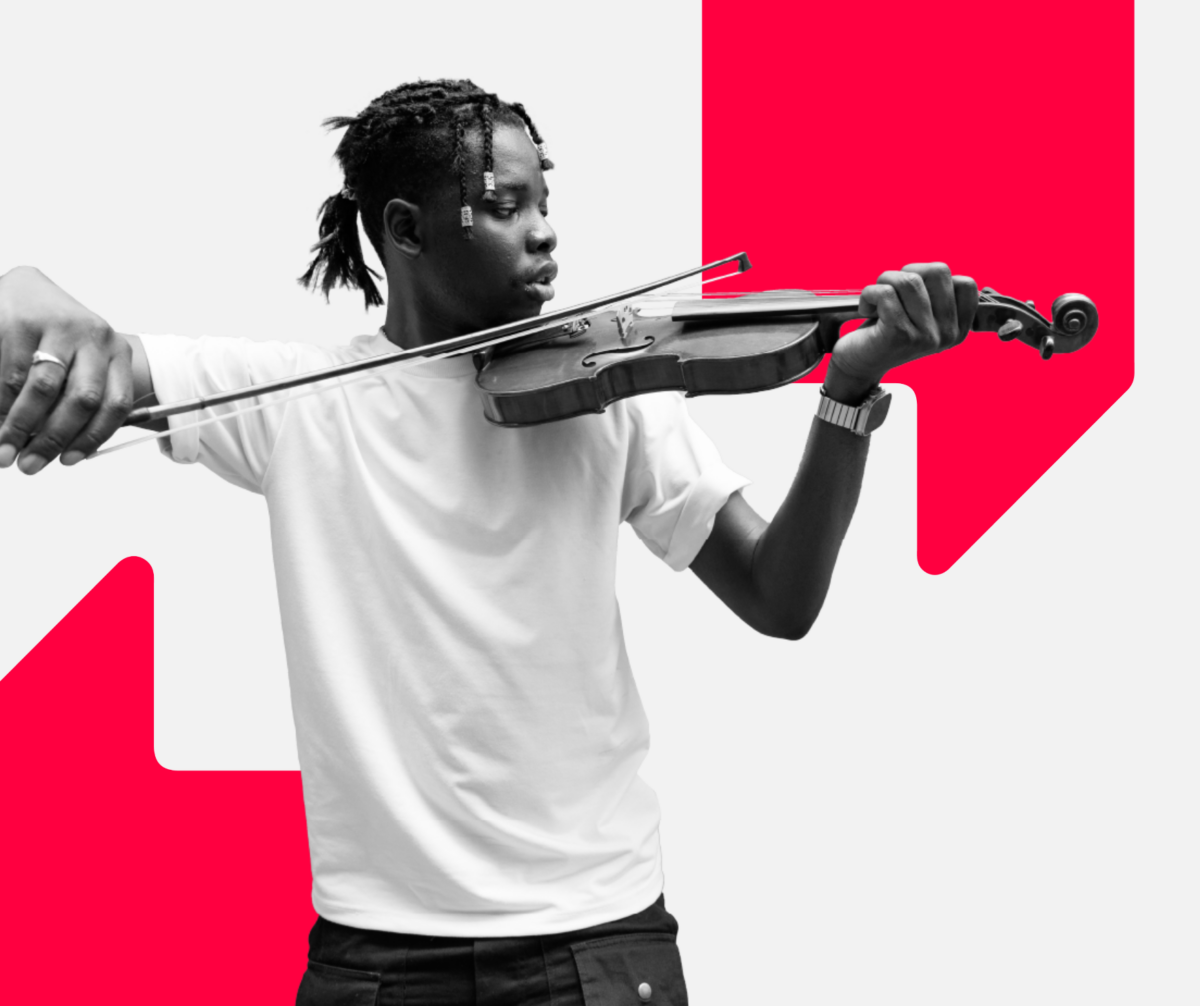 A young boy wearing a white t shirt is playing a violin