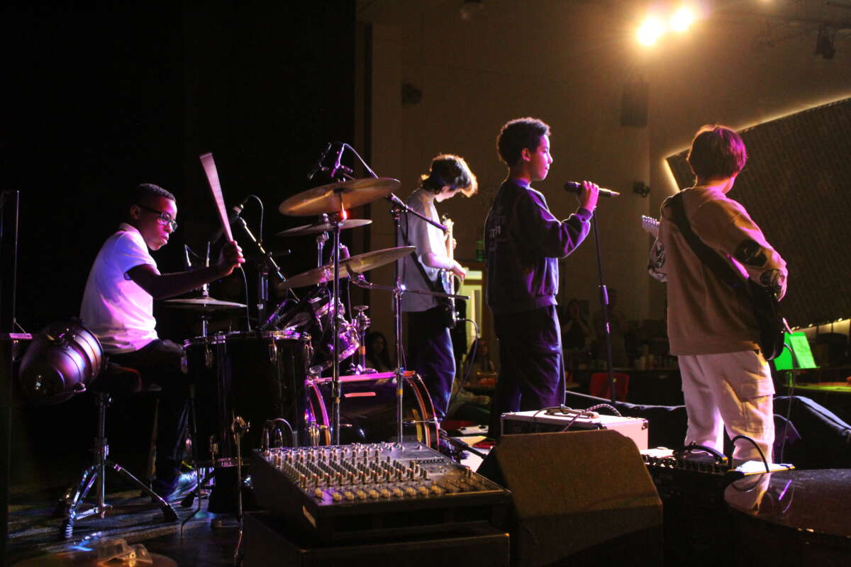A group of young people performing at a gig